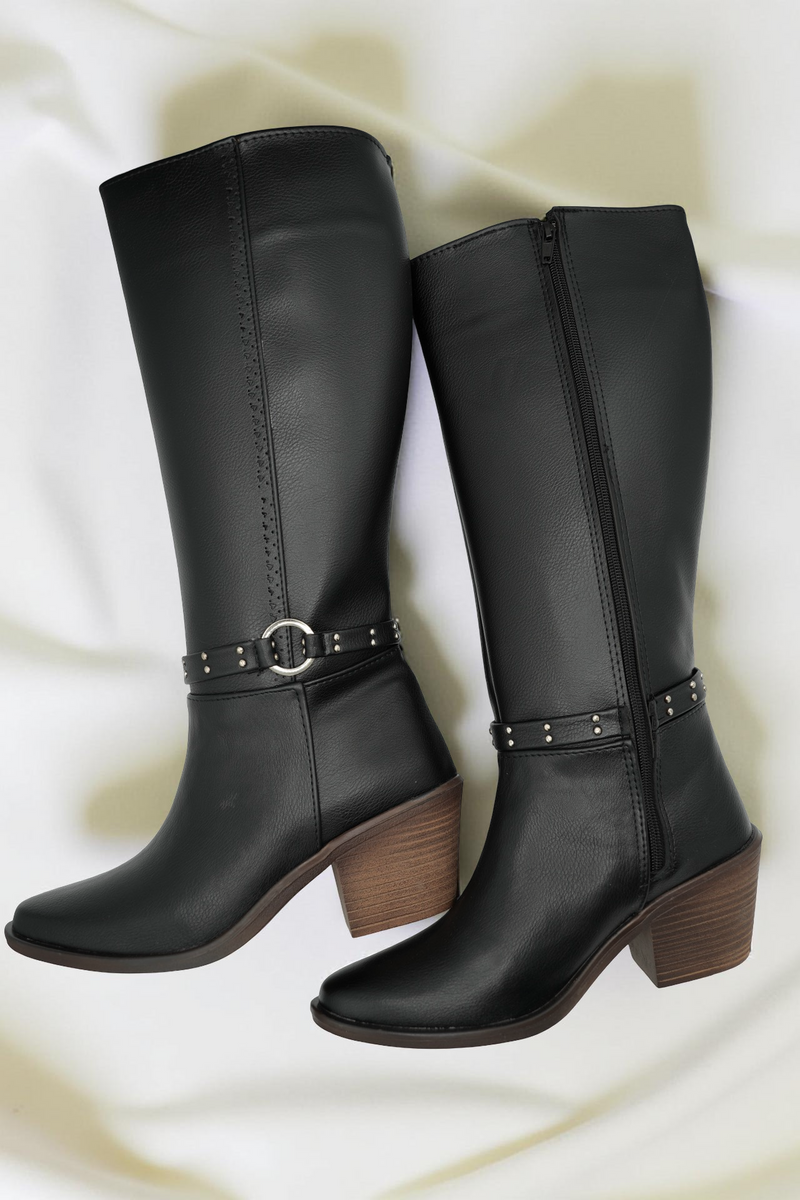 Pair of black leather boots with brown soles on a white background